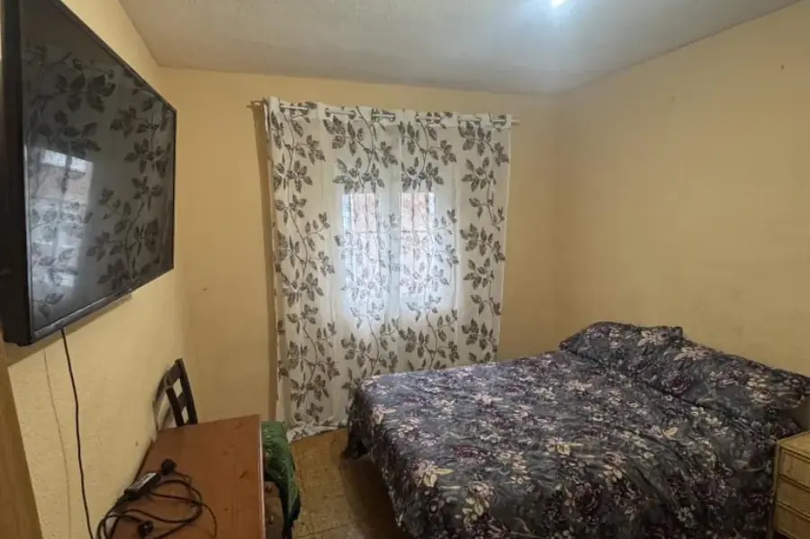 Habitación antes: suelo deteriorado y persiana en mal estado